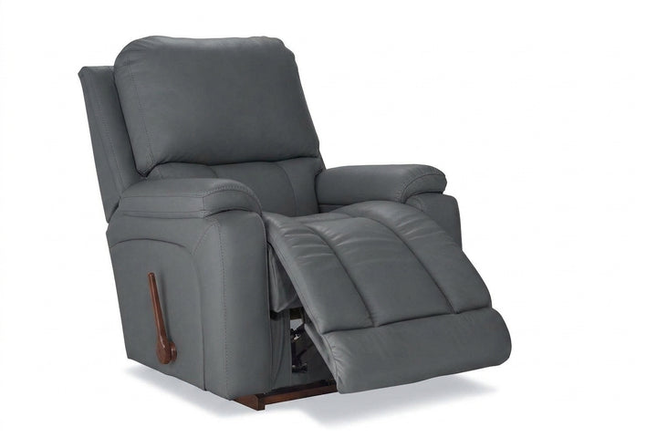 Dark gray leather rocker recliner with padded arms and hinged reclining footrest