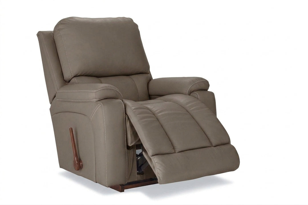 Taupe leather rocker recliner with padded arms and reclining footrest