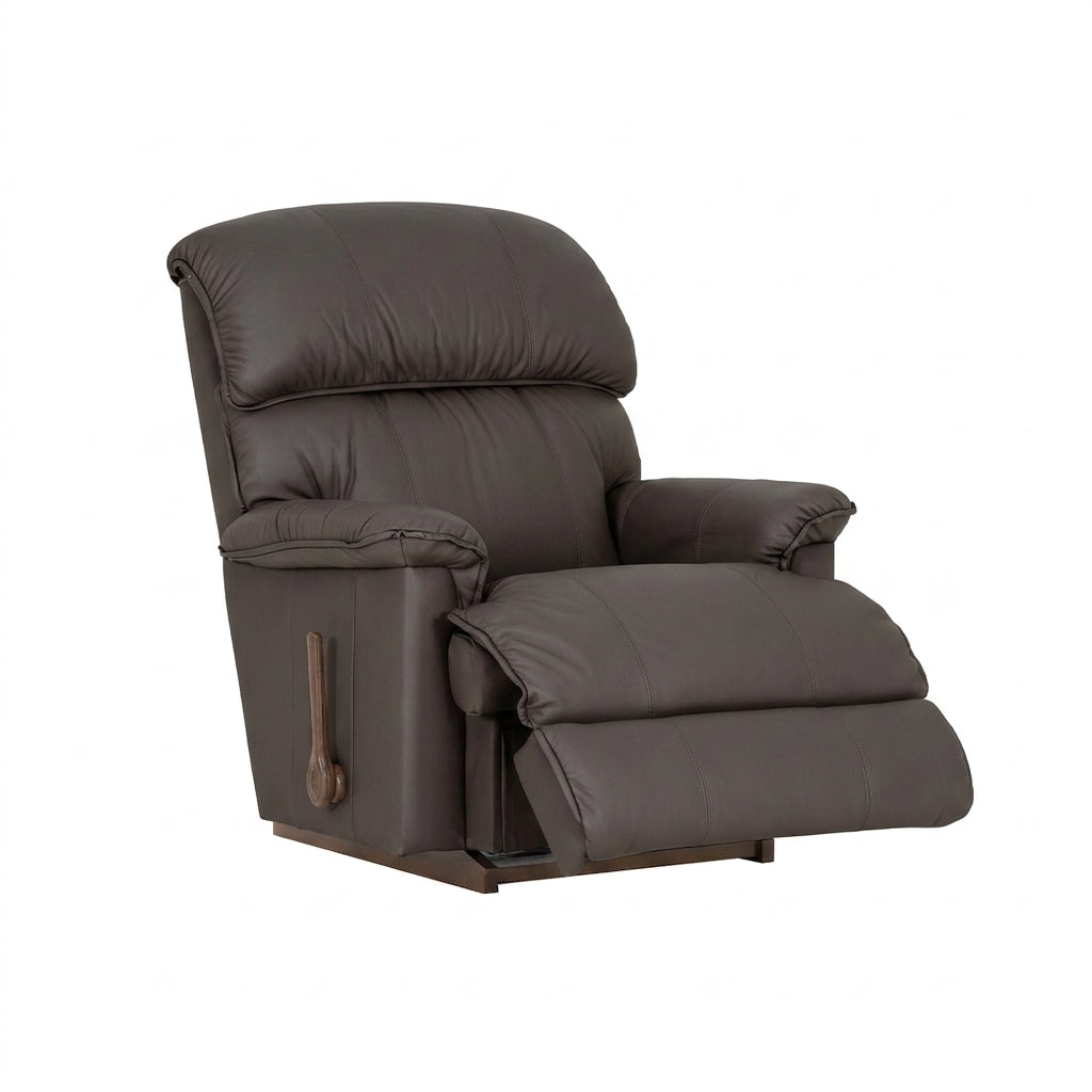 Dark brown leather rocker recliner with padded arms, recline footrest, side handle.