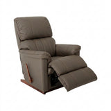 Taupe leather rocker recliner with padded armrests and extended footrest.