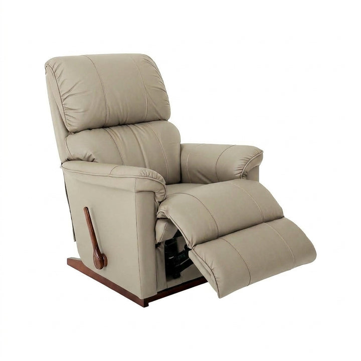 Light beige leather rocker recliner with padded armrests and extended footrest.