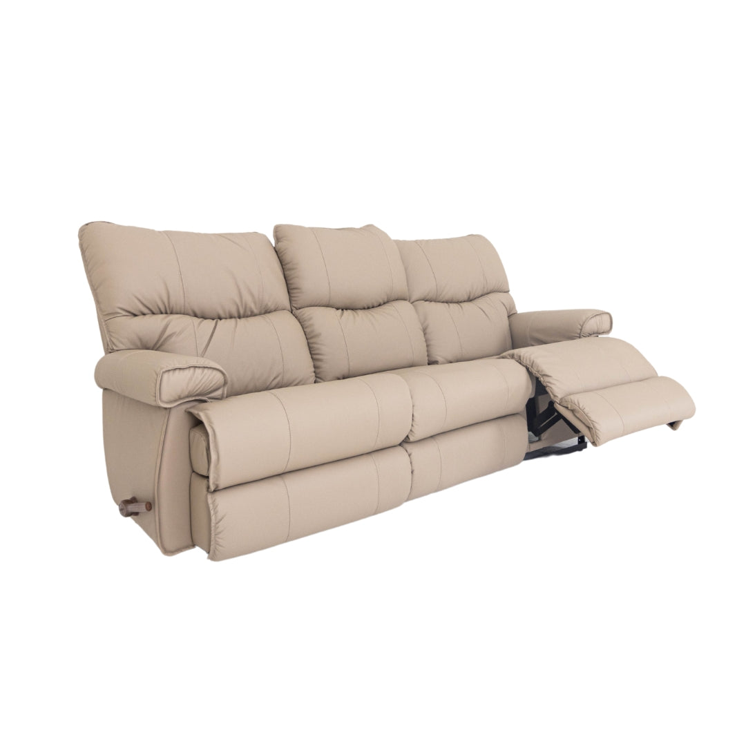 Leather motion reclining sofa in beige leather, tufted back and reclining footrests