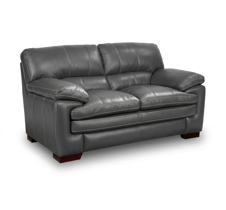 Dark gray leather loveseat with padded arms, tufted back cushions, and cushioned seat