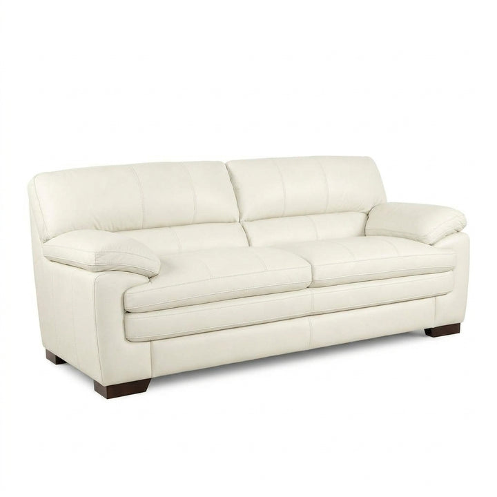 Cream sofa with rolled arms, tuftless back cushions, and dark wooden legs