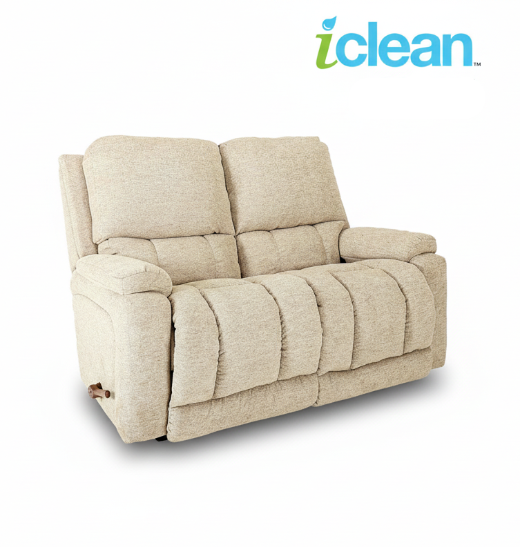 Reclining loveseat with light beige upholstery and padded armrests, reclining seats