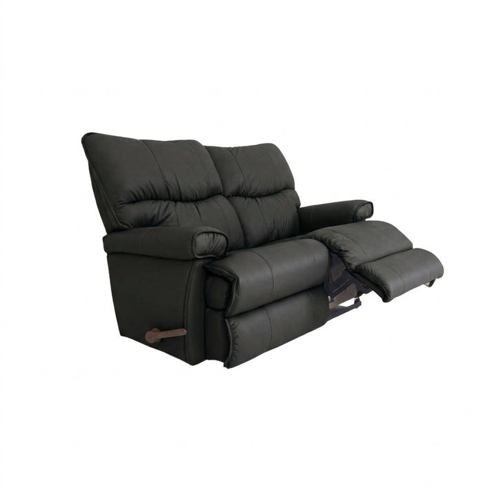 Black leather motion reclining loveseat with padded arms and extended footrest