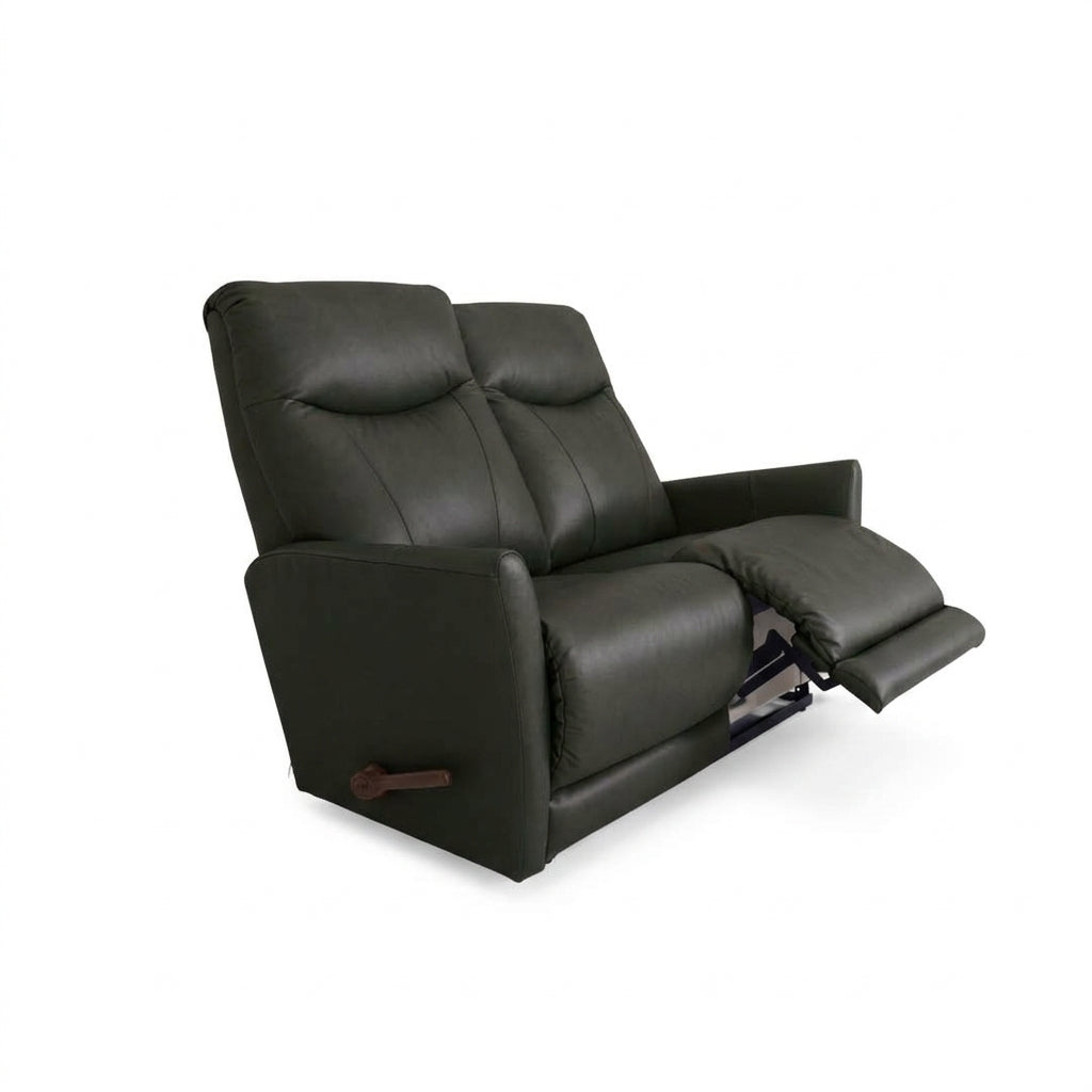 Black leather motion reclining loveseat with two padded headrests and pull tab handle