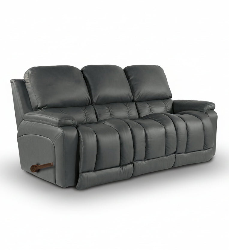 Dark gray leather reclining sofa, three back cushions, wide padded armrests.