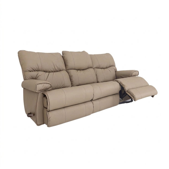 Leather motion reclining sofa in light tan leather, tufted back and reclining footrests