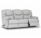 Reclining leather sofa with drop-down side table, tufted back, and padded arms