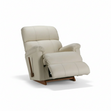Light beige leather rocker recliner shown from side with extended footrest